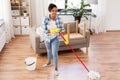 African woman or housewife cleaning floor at home Royalty Free Stock Photo