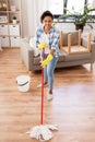 African woman or housewife cleaning floor at home Royalty Free Stock Photo