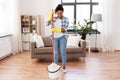 African woman or housewife cleaning floor at home Royalty Free Stock Photo