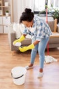 African woman or housewife cleaning floor at home Royalty Free Stock Photo