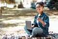 African Woman With Laptop Gesturing Thumbs Up Sitting In Park Royalty Free Stock Photo