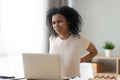 African woman after laptop long usage having lower back pain Royalty Free Stock Photo