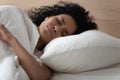 African woman lying in bed has nightmares sleeps bad