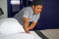 African woman maid making bed in hotel Royalty Free Stock Photo