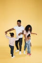 African woman mom, husband and two cute little kids girls, having fun, playing and dancing together Royalty Free Stock Photo