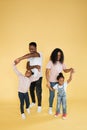 African woman mom, husband and two cute little kids girls, having fun, playing and dancing together Royalty Free Stock Photo