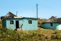 African woman out of her traditional mud house in South Africa. Apartheid, zululand KwaZulu-Natal Royalty Free Stock Photo