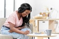 African woman with papers and calculator at home Royalty Free Stock Photo