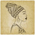 African Woman In Profile In Traditional Head Wrap on vintage background