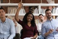 African woman raising hand to ask question at team training Royalty Free Stock Photo