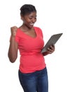 African woman in red shirt winning internet auction