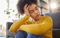 African woman, sad and thinking on living room floor with worry, stress and memory of trauma in home. Gen z girl