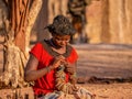 An African woman selling crafts in a Himba village in Namibia.