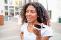 African woman sending voice message on mobile phone Royalty Free Stock Photo