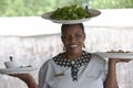 African woman serving salat on the head
