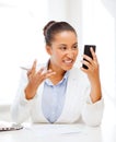 African woman shouting into smartphone Royalty Free Stock Photo