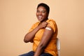 African Woman Showing Covid-19 Vaccinated Arm With Plaster, Beige Background