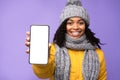 African Woman Showing Smartphone Empty Screen Over Purple Background Royalty Free Stock Photo