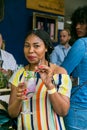 African woman sipping a cocktail and generally enjoying a day out at a Food and Wine Fair