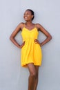 African woman smiling in elegant yellow dress