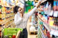 African Woman Talking On Mobile Phone Buying Food In Supermarket Royalty Free Stock Photo