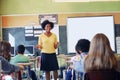 African woman, teacher and classroom discussion with students for education, learning support and knowledge development Royalty Free Stock Photo