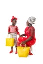 African woman in traditional clothing and little girl with tote bags.Isolated Royalty Free Stock Photo