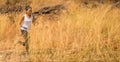 African woman Trail running in Meadow on mountain outdoor. sport adventure . black female runner  jogging on country path or cross Royalty Free Stock Photo