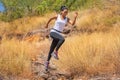 African woman Trail running in Meadow on mountain outdoor. sport adventure . black female runner and   jumping on country path or Royalty Free Stock Photo