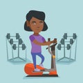 African woman exercising on elliptical trainer. Royalty Free Stock Photo