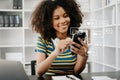 African woman typing smartphone, keyboard with laptop computer of Social media and Marketing virtual icons screen concept. in Royalty Free Stock Photo