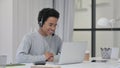African Woman using Headset for Video Chat on Laptop Royalty Free Stock Photo
