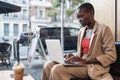 African woman using a laptop in a coffee sho