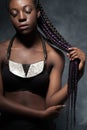 African woman with very long hair braided in multi-colored braid