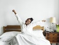 An african woman waking up in bed Royalty Free Stock Photo