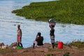 African woman wash clothes on the shore of Lake Victoria