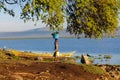 African woman wash clothes on the shore of Lake Victoria