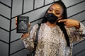 African woman wearing black face mask show Malawi passport in hand. Coronavirus in Africa country, border closure and quarantine,