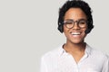 African woman wearing headset with microphone posing isolated on grey Royalty Free Stock Photo