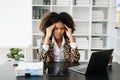 African Woman who is tired and overthinking from working with tablet and laptop at office Royalty Free Stock Photo