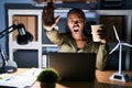 African woman working using computer laptop at night doing stop gesture with hands palms, angry and frustration expression Royalty Free Stock Photo