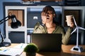 African woman working using computer laptop at night yawning tired covering half face, eye and mouth with hand Royalty Free Stock Photo