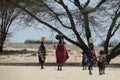 African women and children carrying water on their heads in buckets in the arid Turkana region Royalty Free Stock Photo