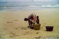 African women collecting fresh fish on a beach near Accra, Ghana, c.1959