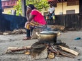 African women cooking meal over simple wood fire at Albert Schwe Royalty Free Stock Photo