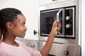 African Women Hand Opening The Oven Door Royalty Free Stock Photo