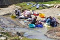 African women washing clothes on a river. Washed clothes are lie Royalty Free Stock Photo