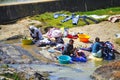 African women washing clothes on a river. Washed clothes are lie Royalty Free Stock Photo