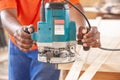 Carpenter using a router