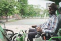 African worker driving heavy construction equipment backhoe with smile and happy